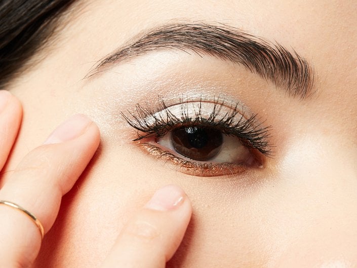 person with long eyelashes wearing silver eyeshadow