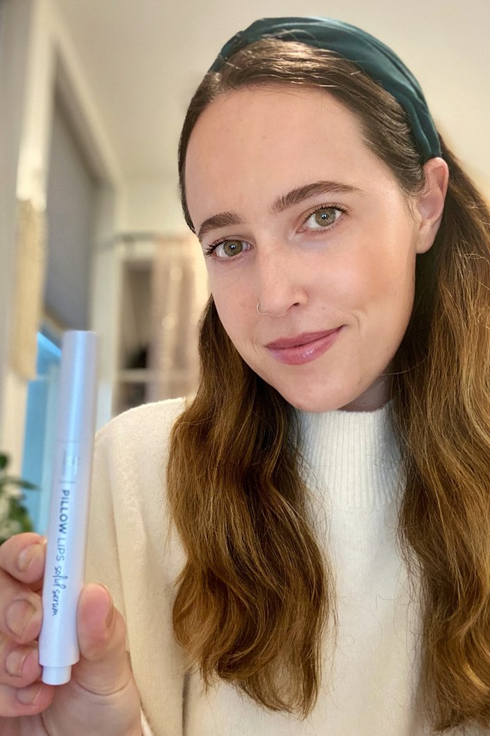 person wearing IT Cosmetics Pillow Lips Solid Serum Lip Gloss in Like a Dream