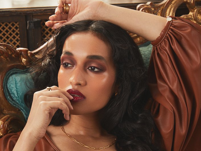 person wearing burgundy eye makeup and lipstick