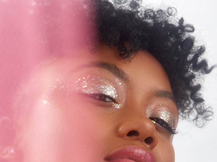 person wearing glitter eye makeup