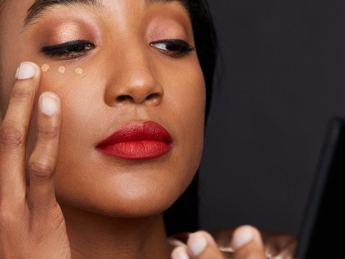 person applying concealer under eye