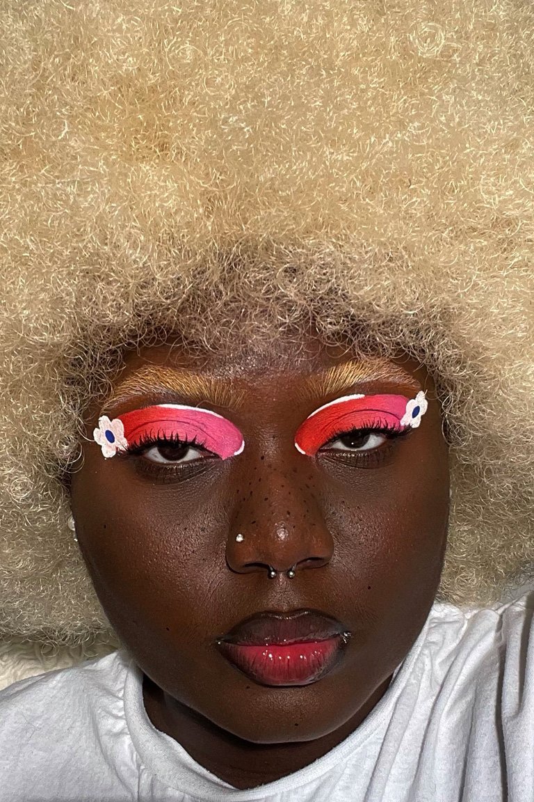 person wearing pink ombre flower eye makeup