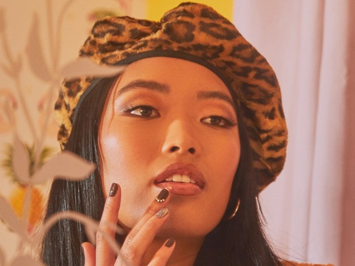 person wearing opaque lip gloss and looking in mirror