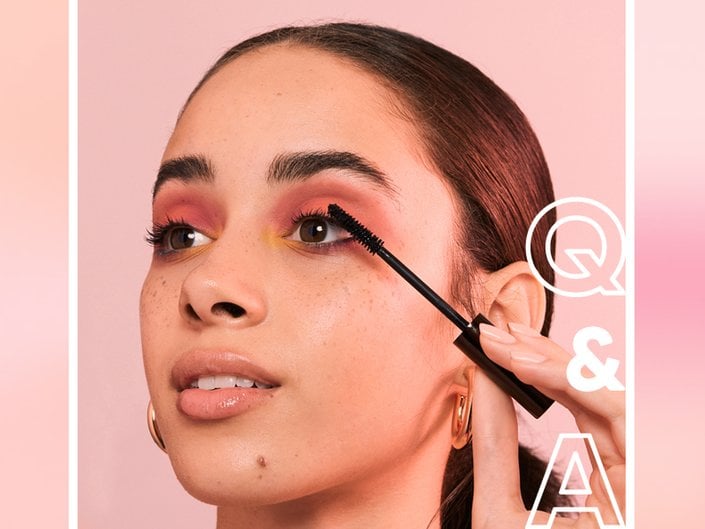 person applying mascara to eyelashes