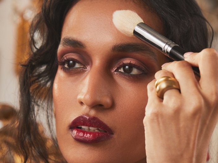 person wearing burgundy smokey eyeshadow and lipstick