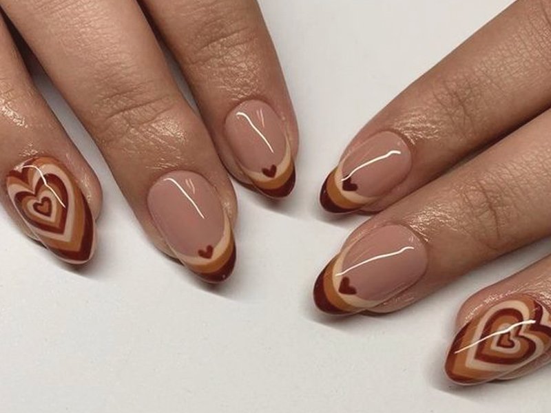 hands with brown nail art on nails