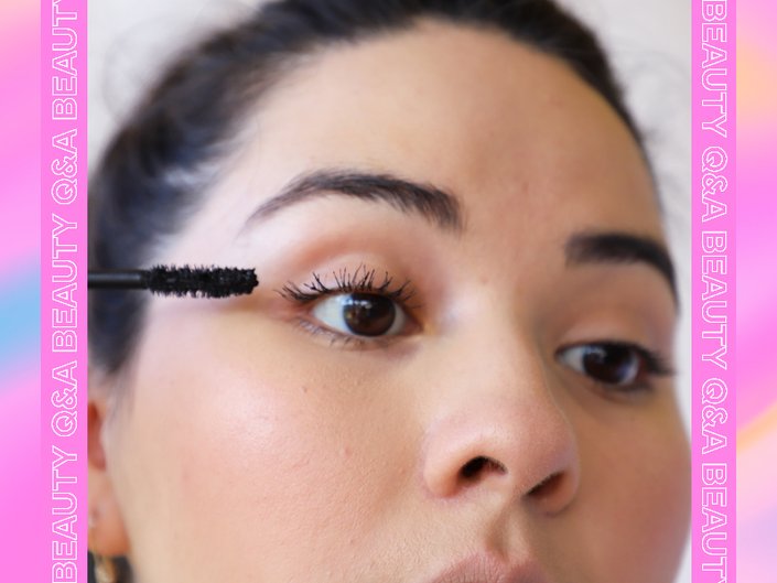 person holding mascara wand to eye