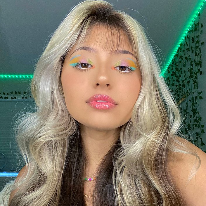 person wearing colorful eye makeup