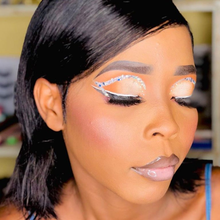 person wearing glitter eye makeup