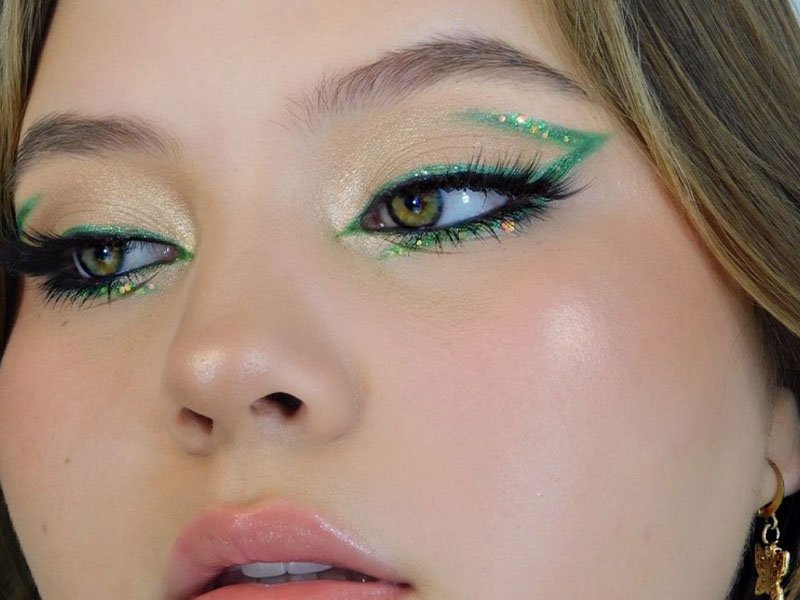 person wearing green glitter eyeliner