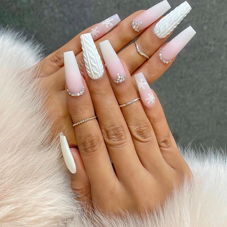 hands with white nail art on nails
