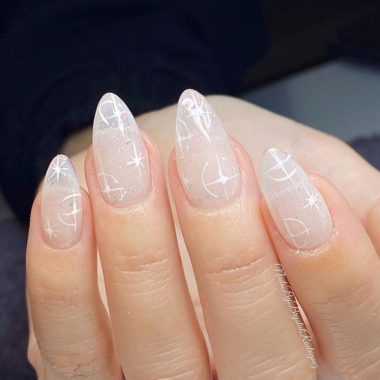 hand with snowflake nail art on nails