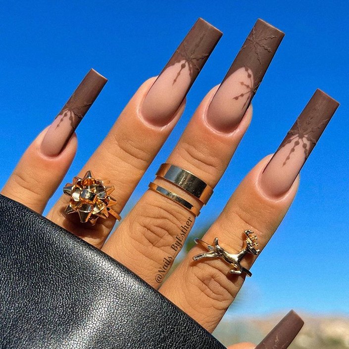 hand with brown matte textured polish on nails