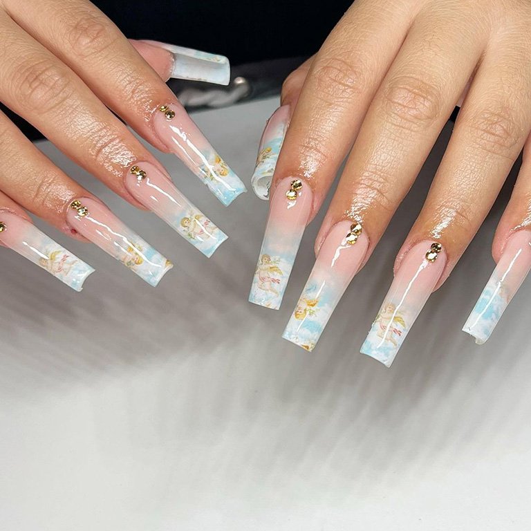 hands with angel nail art on nails