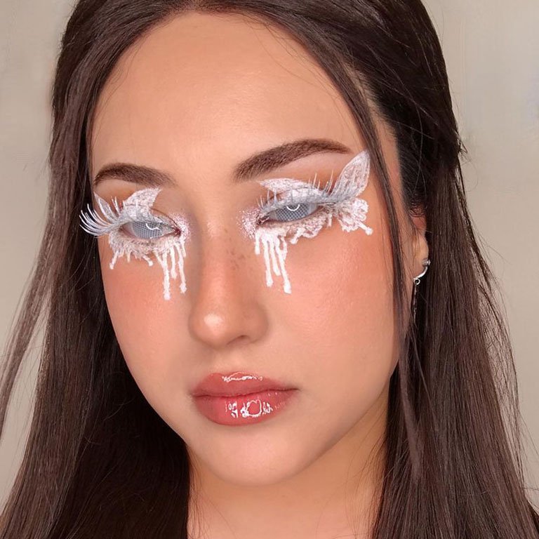 person wearing white eye makeup