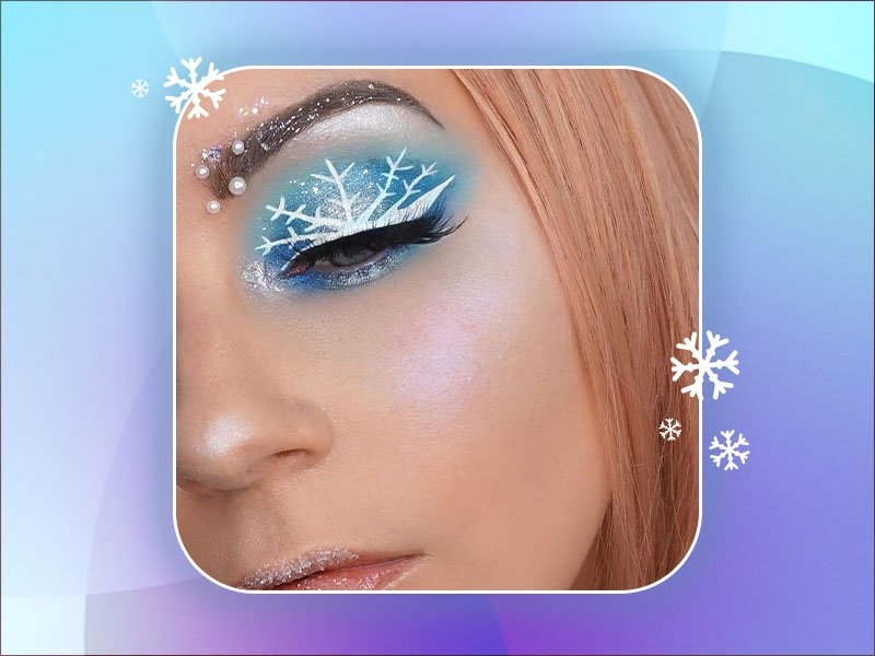 person wearing blue eyeshadow with white snowflake
