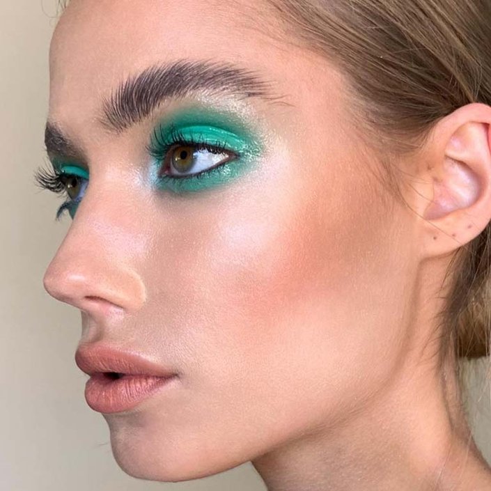 person wearing glossy green eyeshadow