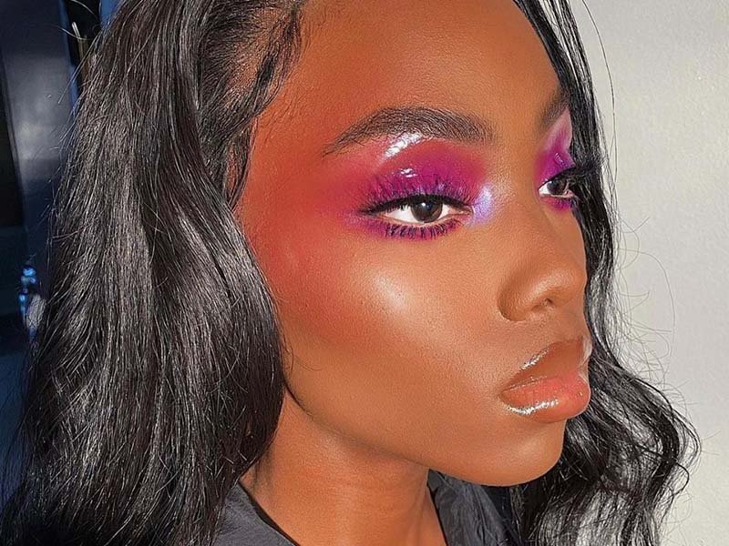 person wearing glossy pink and red eyeshadow