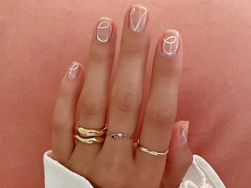 person wearing white nail art on nails