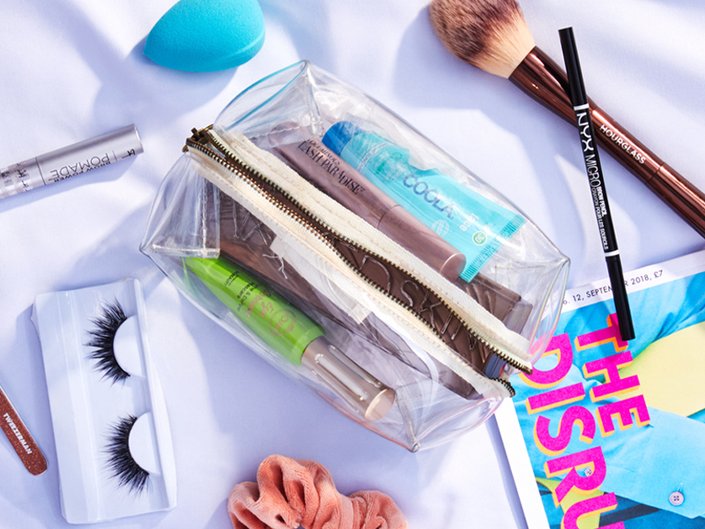 makeup products inside and surrounding a makeup bag