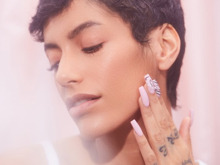 person with pixie haircut posing with hand on face