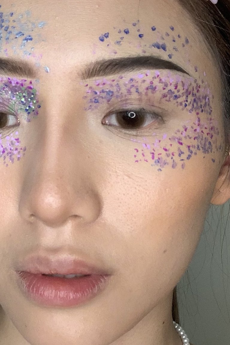 person wearing colorful pointillism makeup look