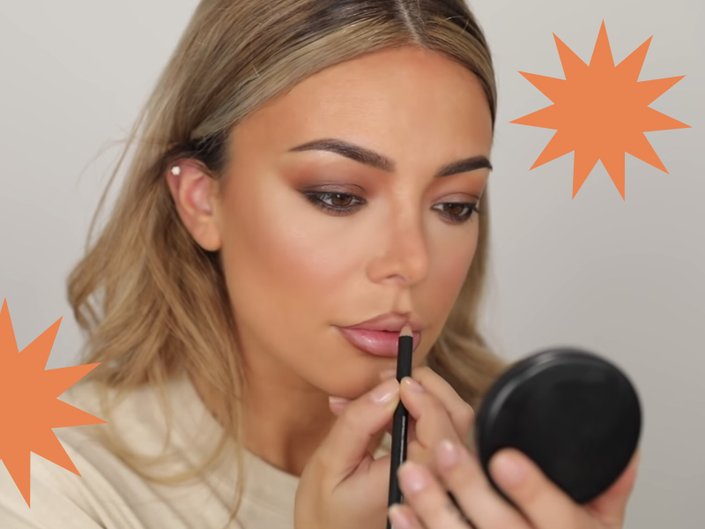 person applying lip liner in compact mirror