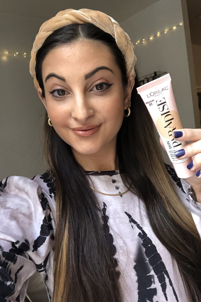 person wearing l'oreal paris skin paradise water-infused tinted moisturizer in medium 01