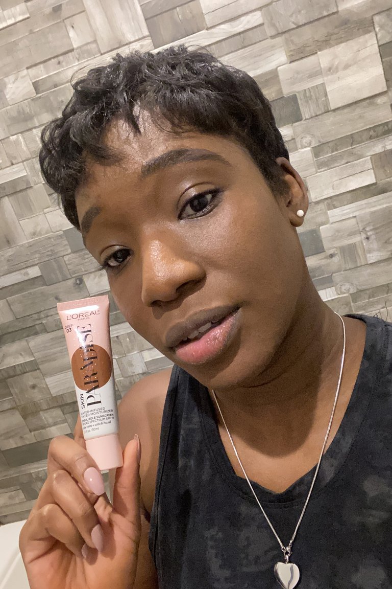 person wearing l'oreal paris skin paradise water-infused tinted moisturizer in deep 03