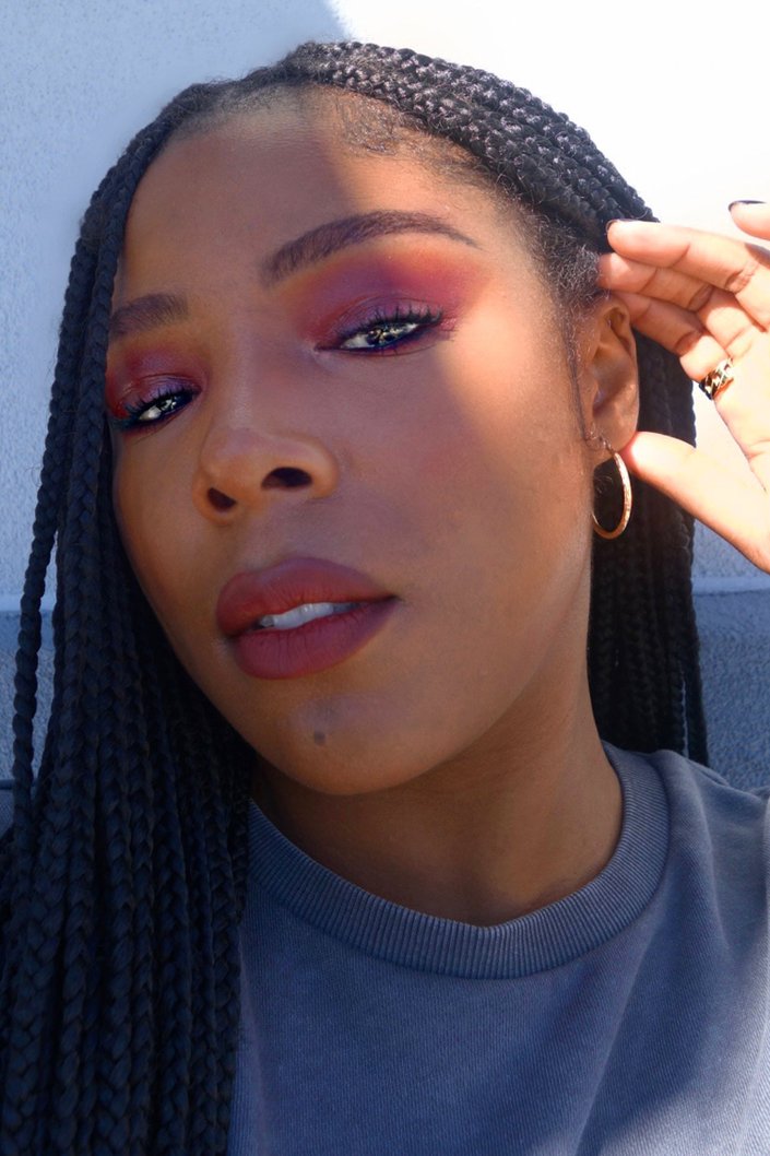 person wearing red eyeshadow and lipstick