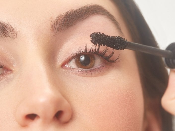 person applying mascara