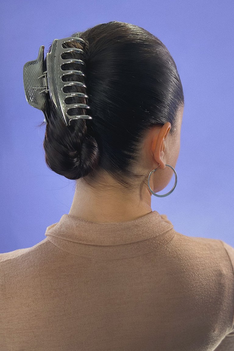 person wearing a double french twist with a claw clip