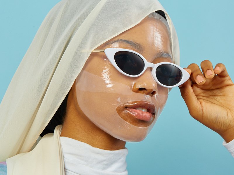 person wearing sheet mask and sunglasses