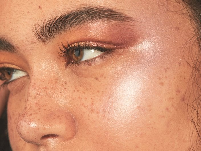 person wearing highlighter on eyelid and cheekbone