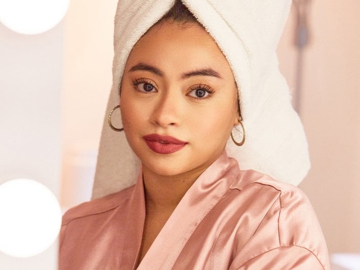person wearing white towel on head and red lipstick
