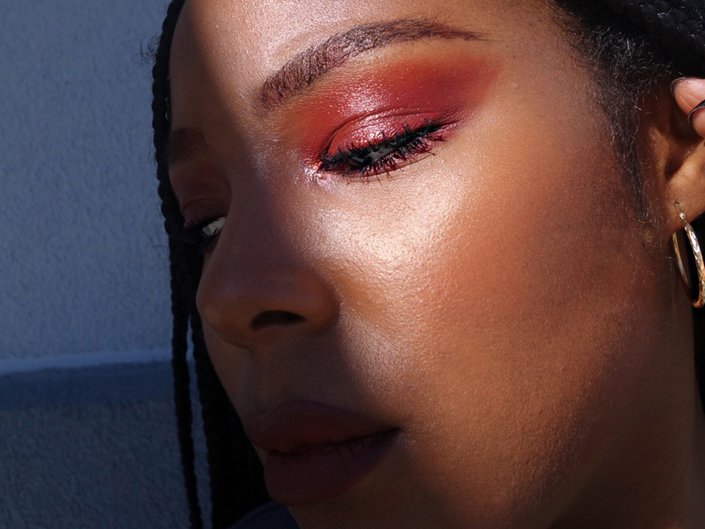 person wearing red eyeshadow and lipstick