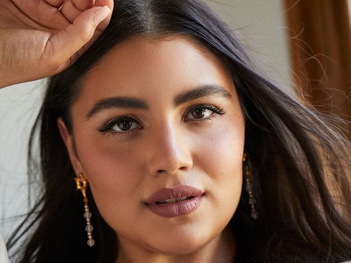 Person with a nude makeup look looking at the camera