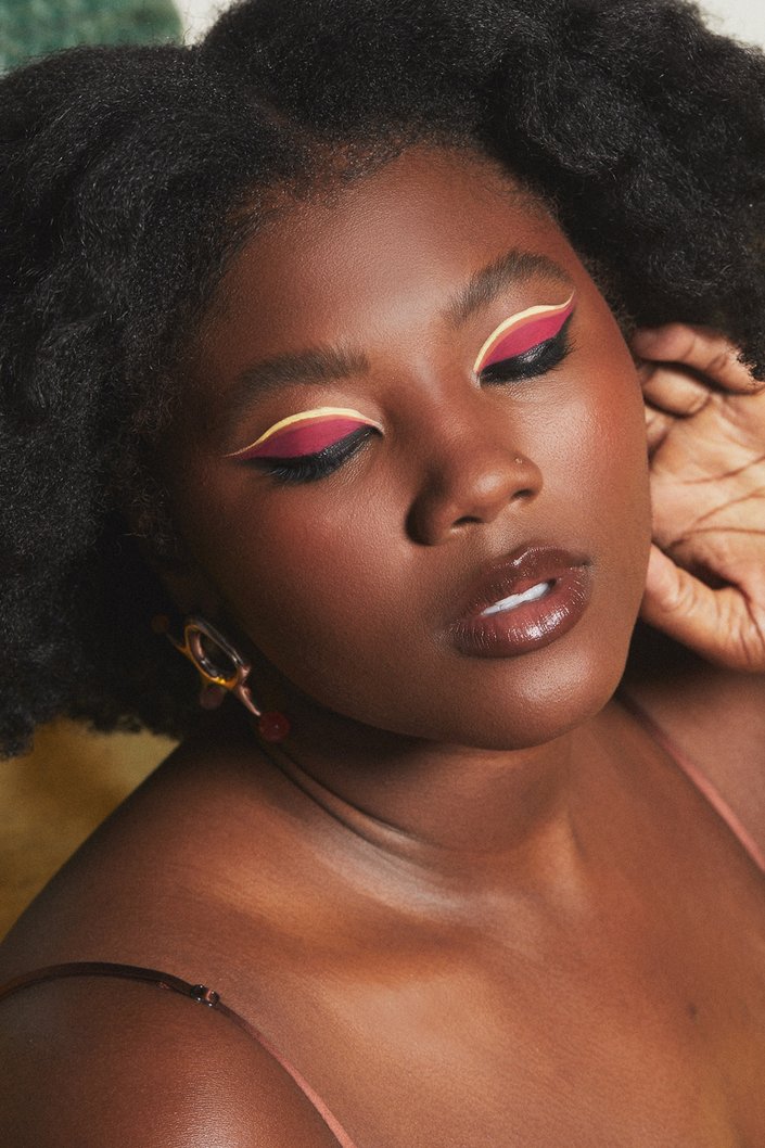person wearing colorful graphic eye makeup