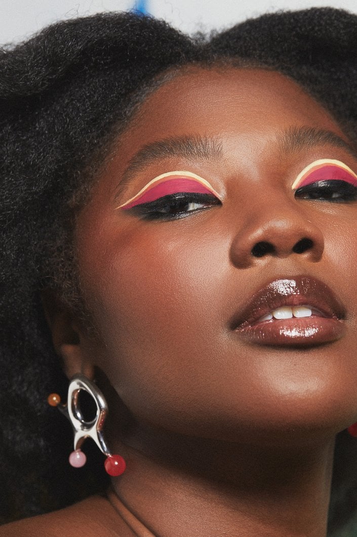 person wearing colorful graphic eye makeup