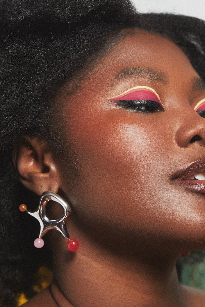 person wearing colorful graphic eye makeup