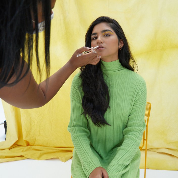 person getting makeup applied to lips