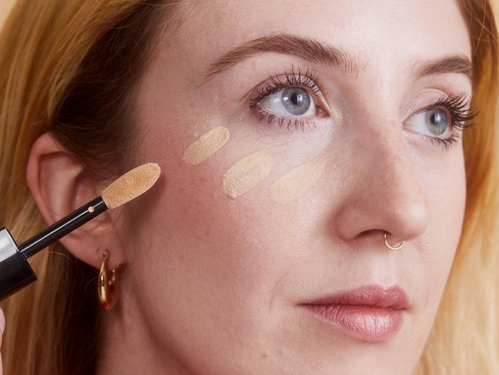 person applying concealer to face