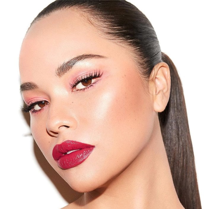 person wearing pink eyeshadow and red lipstick