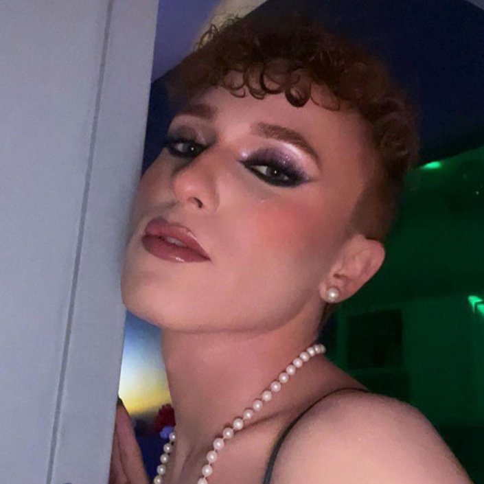 person wearing purple glitter eyeshadow and nude lipstick
