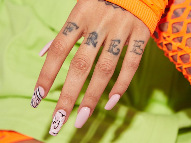 hand with pink nails and nail art