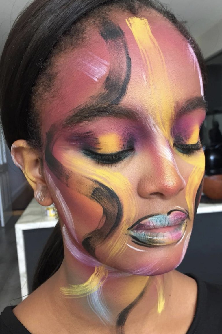 person wearing colorful abstract face makeup