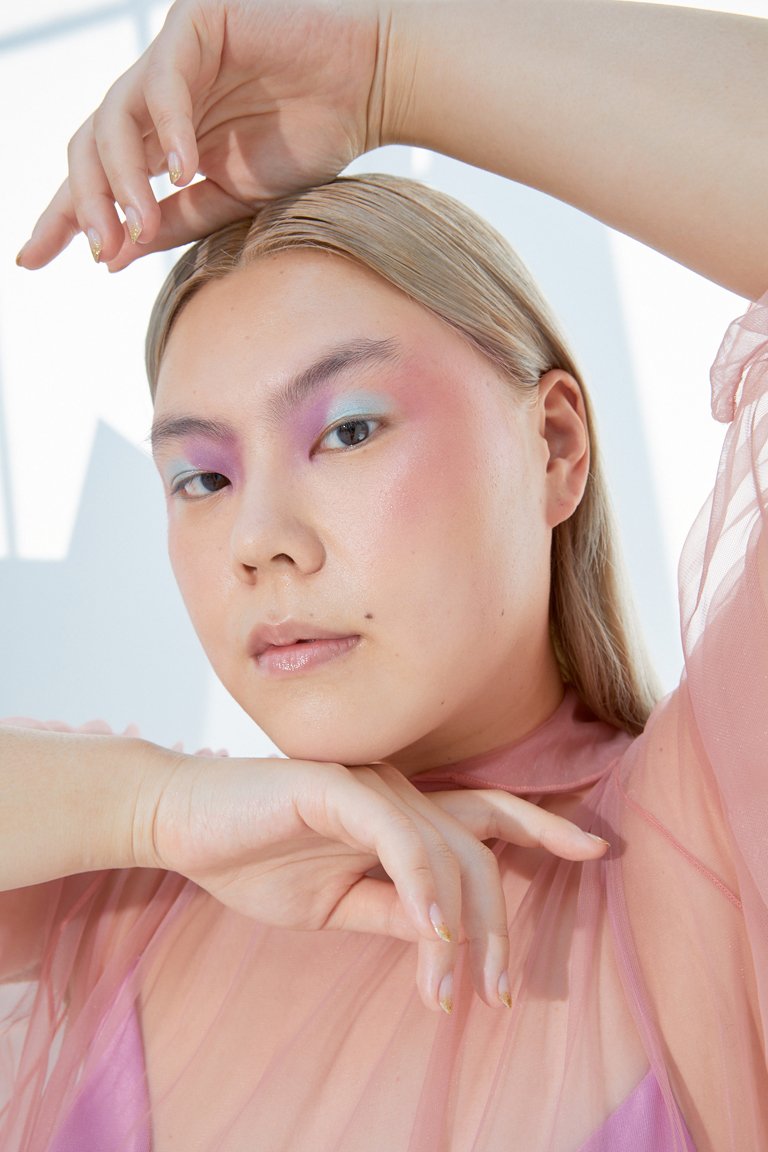 person wearing pink blush and colorful eyeshadow