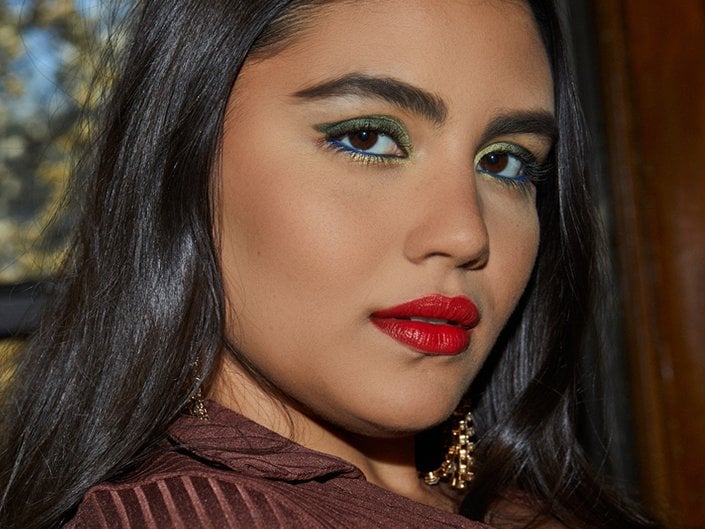 Photo of a model with brown eyes and metallic green eyeshadow