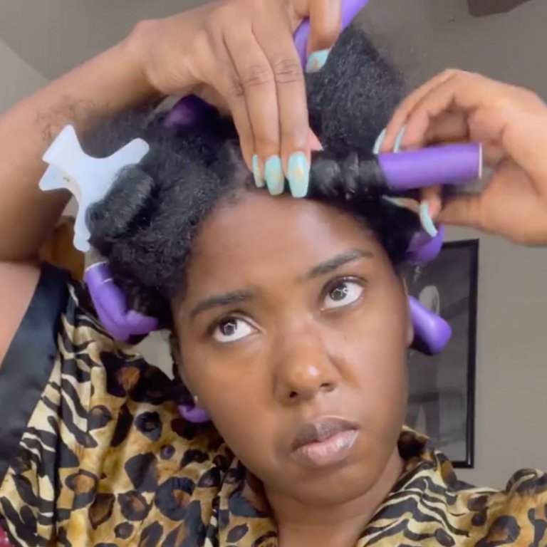 person styling hair with flexi rods