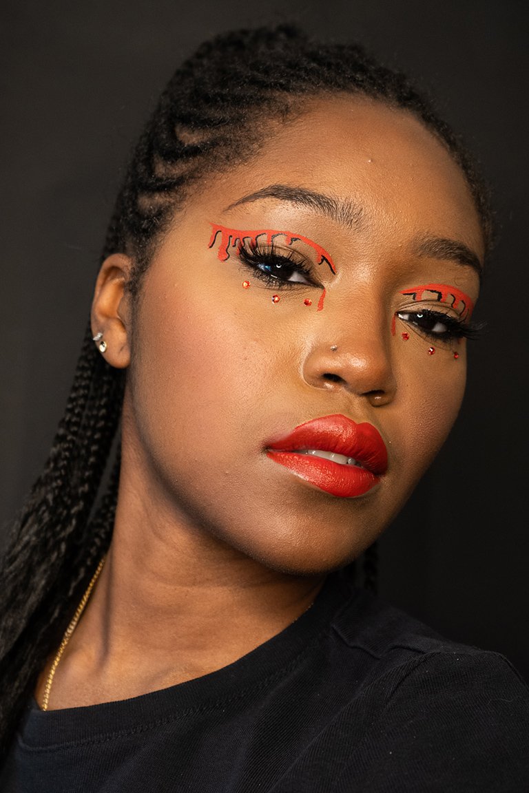 person wearing red eye makeup and red lipstick